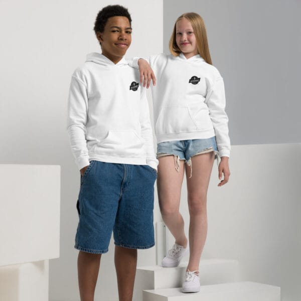 Casual young people wearing white hoodies with Big Barber Delux logo, showing trendy streetwear fashion at a barber shop or promotional photoshoot.